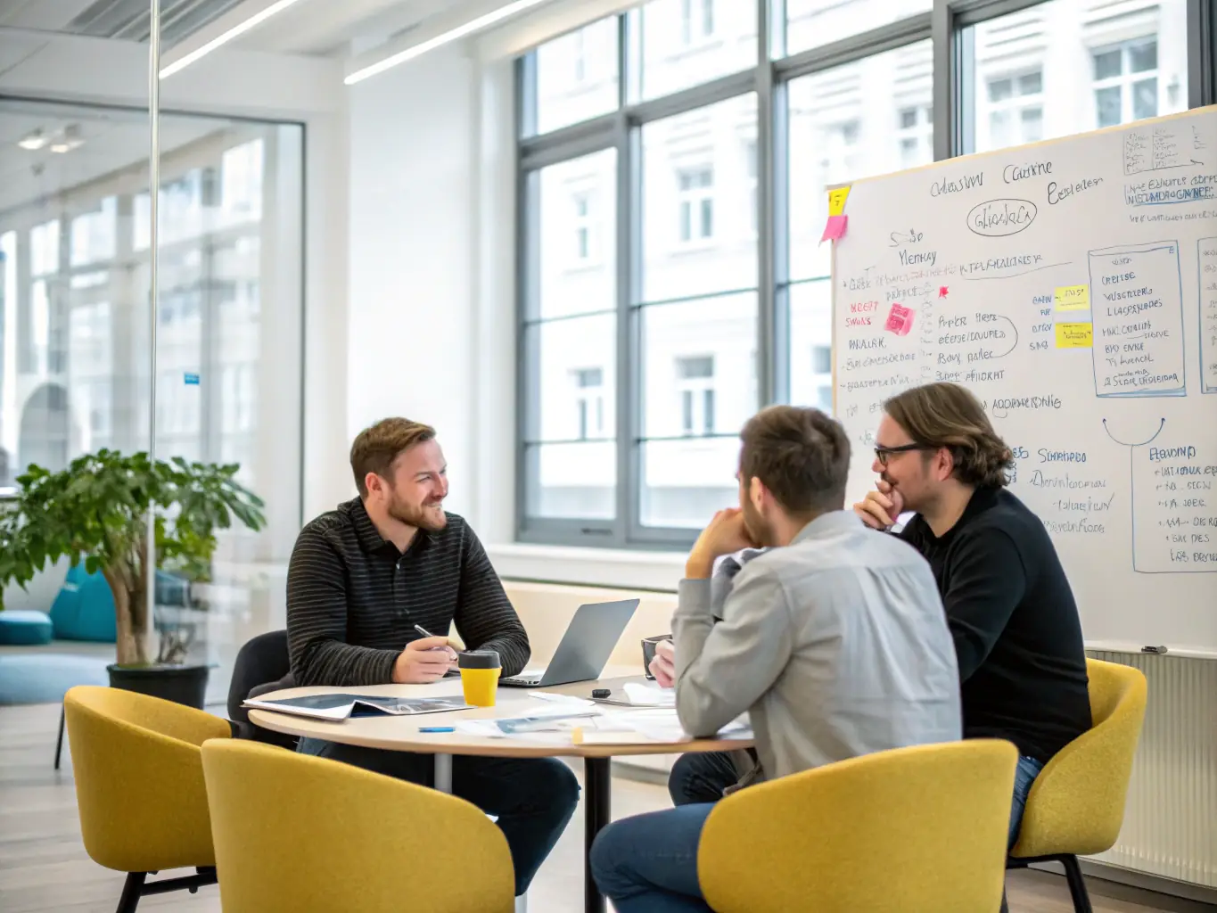 A coach facilitating a strategic planning session with a startup team, using visual aids and collaborative tools to map out the company's future.